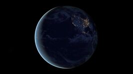 View of Earth from space, showcasing the radiant lights of North America during the night while the sun bathes the left side of the planet in a warm glow.