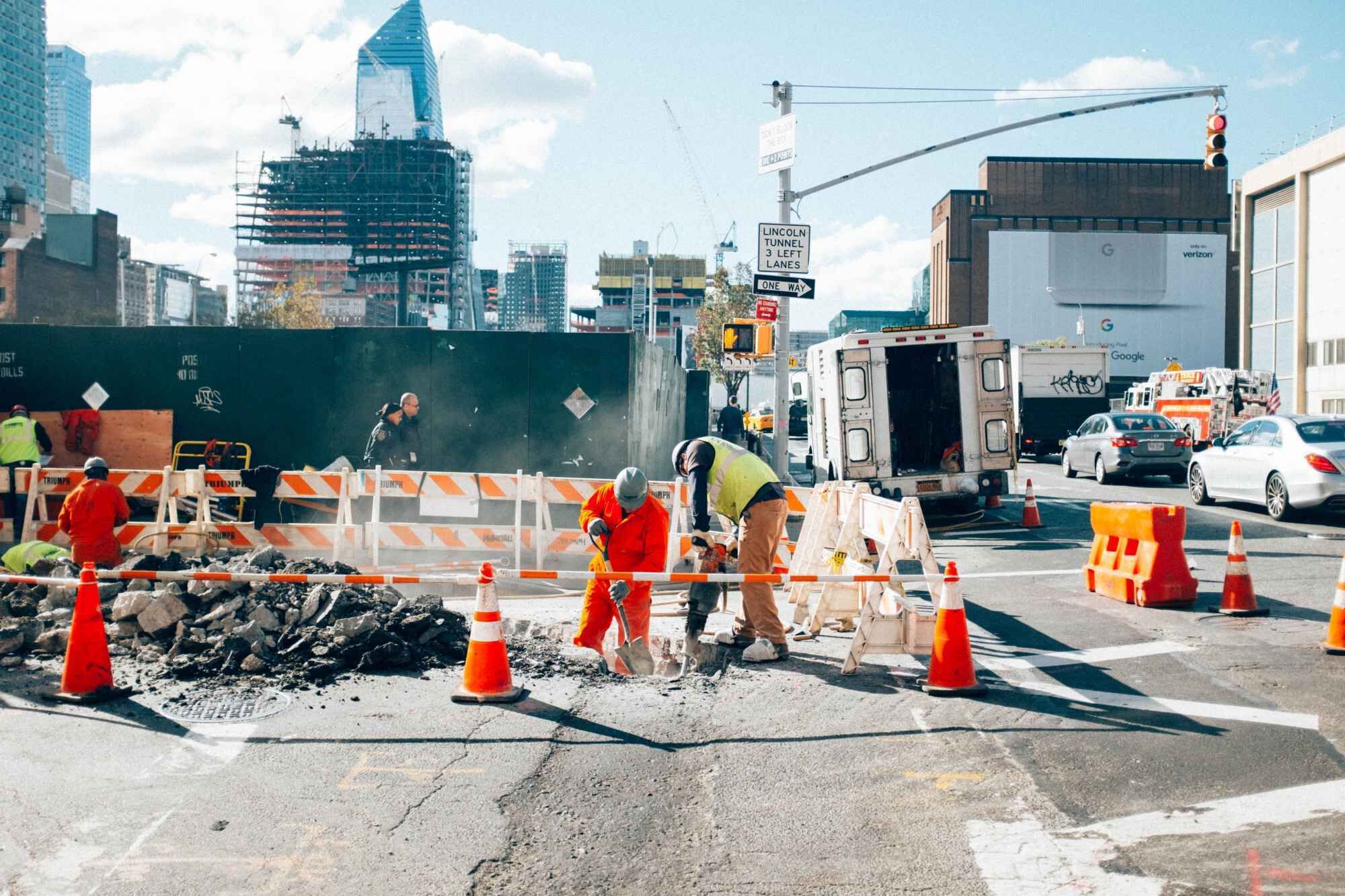 Busy scene of construction workers carrying out tasks on a street in New York City