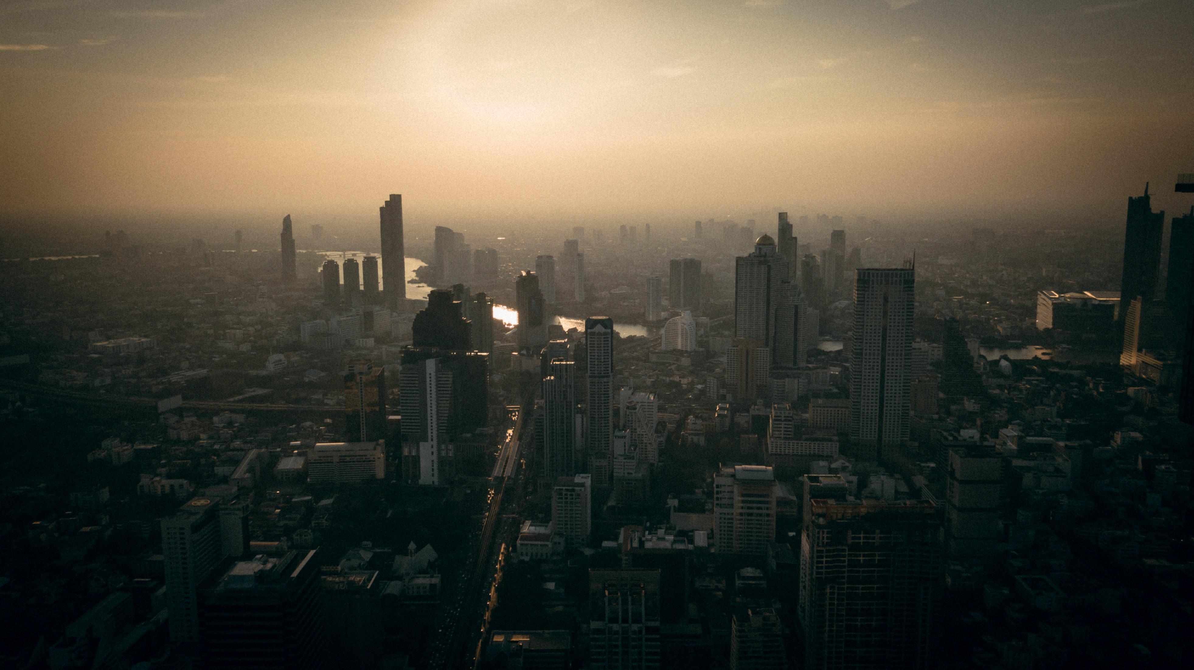 Atmospheric city view at dawn, with skyscrapers emerging from the ethereal morning fog