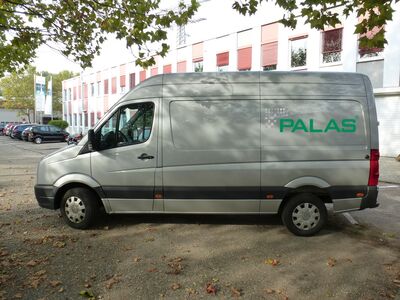 Silver Vehicle with Logo Standing Infront of the Palas Headquarters