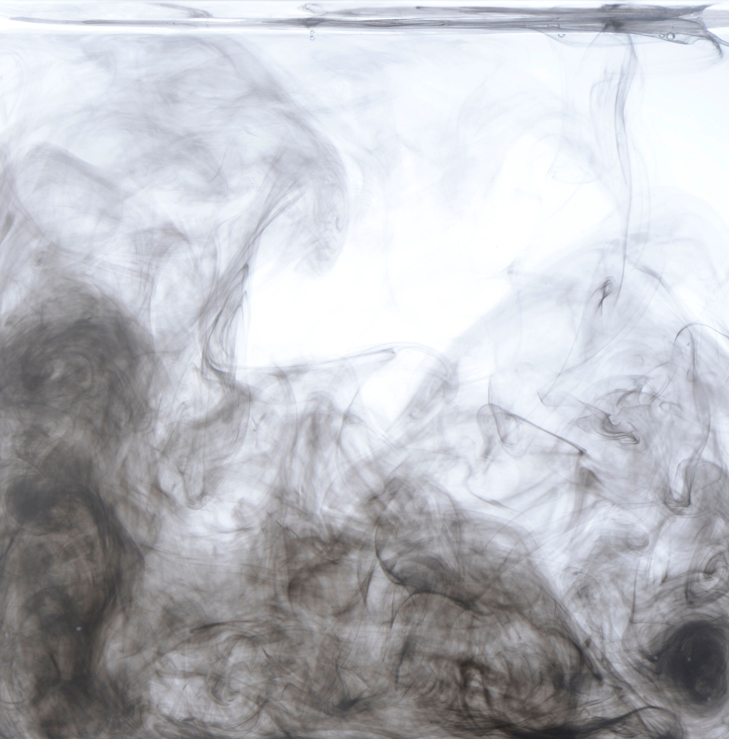 Billows of black smoke in front of a white background, measured by the Palas Dilution systems with dilution factors of 1:10 up to 1:1,000,000.