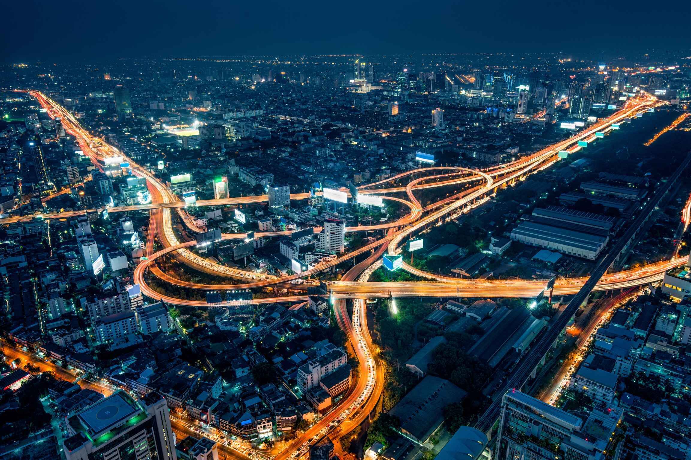 City Lights: A stunning view of enlightened streets at night, showcasing the intricate network of urban roadways